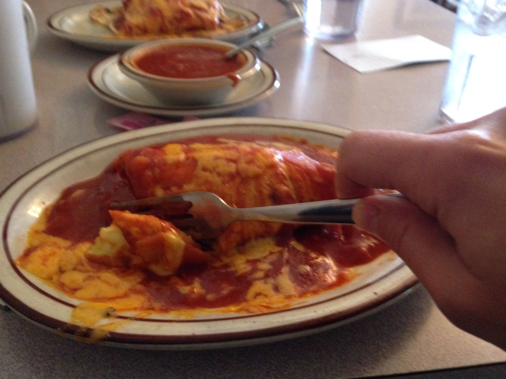 Red chile smothered sausage, egg, and cheese burrito, with extra red chile 